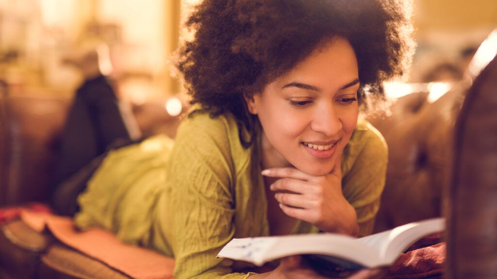 Woman reading a positive book to read