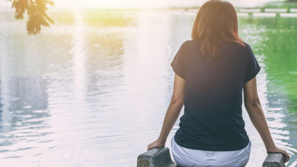 Woman looking at a lake.