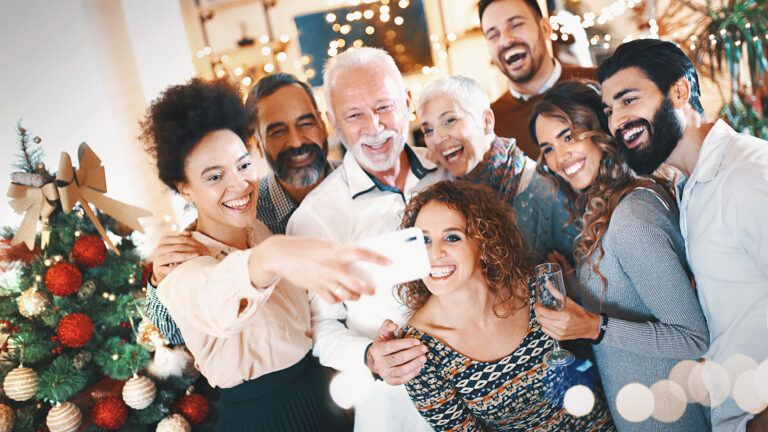 A group of friends taking a Christmas party selfie