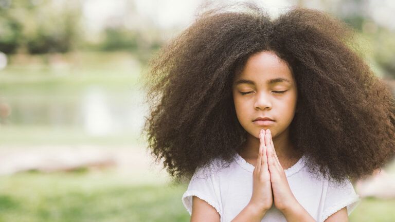 A young girl offers a prayer of thanks