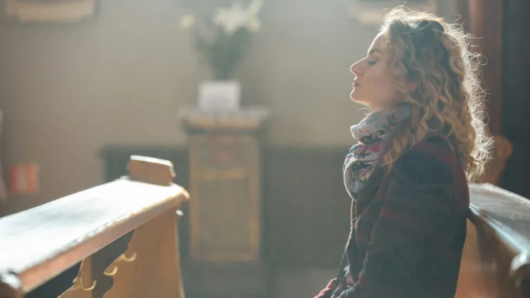 Woman in church pew