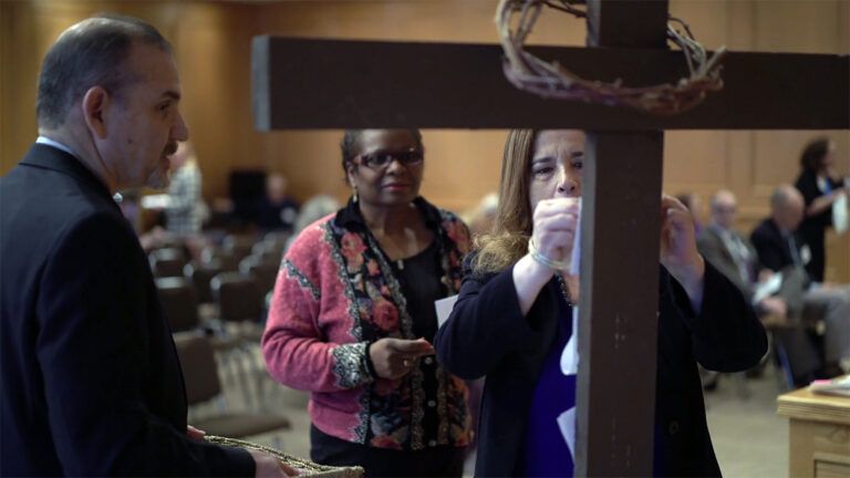 Volunteers post requests that have been raised up in prayer on Good Friday