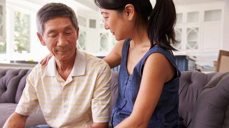 An adult daughter with her senior father