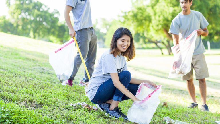 Helping pick up trash in a park