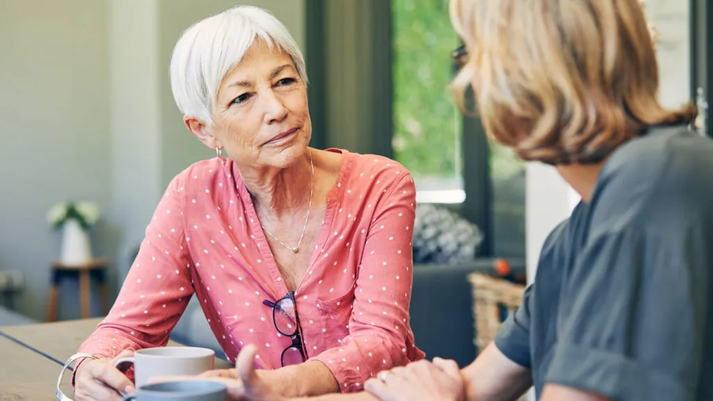 A caregiver communicating with an older loved one.