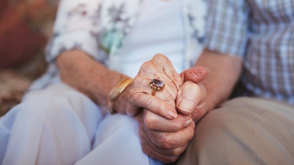 Senior couple holding hands