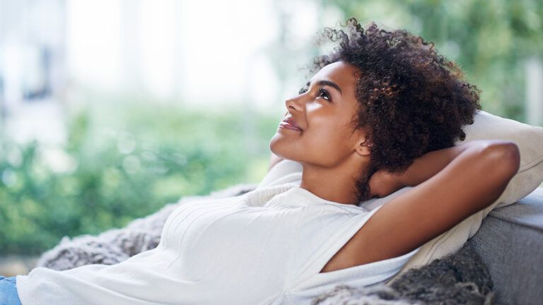 A smiling woman gazes heavenward