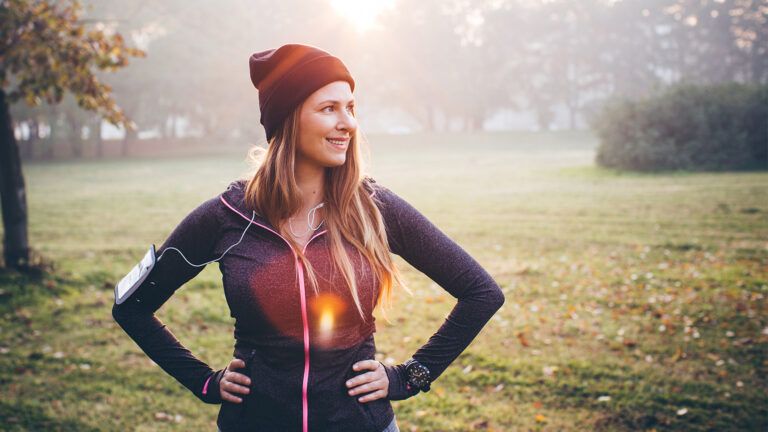 A smiling woman rests after exercising