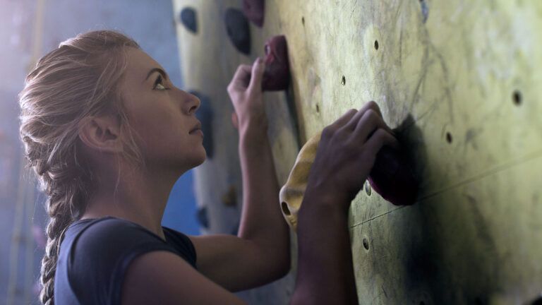 Woman climbing wall