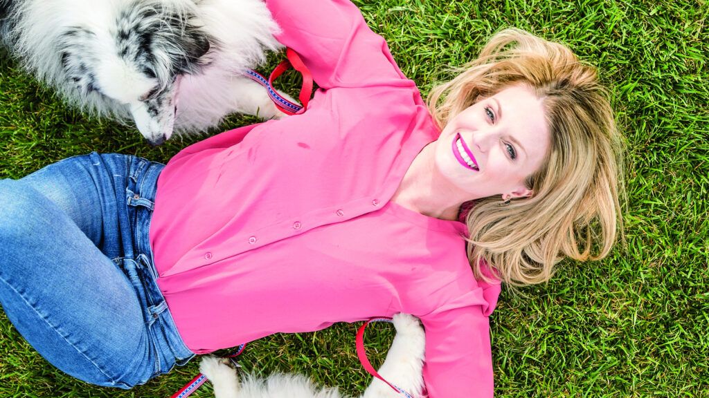 Alisa Johnson, founder of Dogs on Deployment, poses with her two dogs.