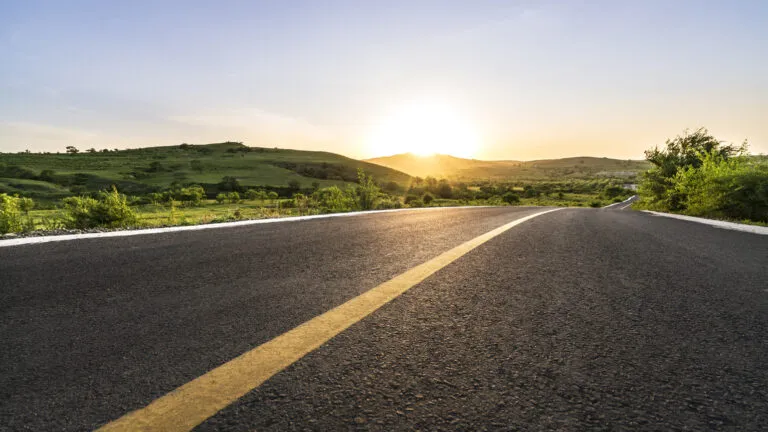 A road with sunshine at the end.