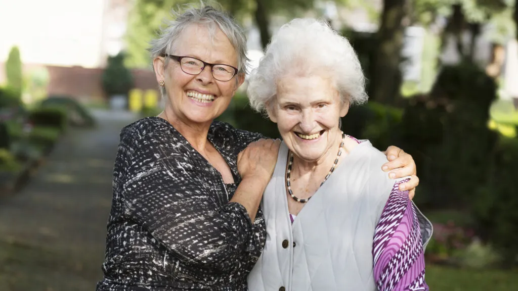 A mother in her golden years with her daughter.