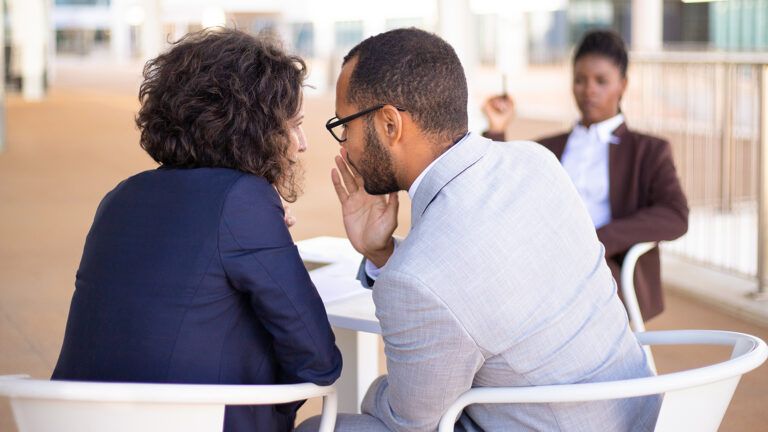 Two people gossiping