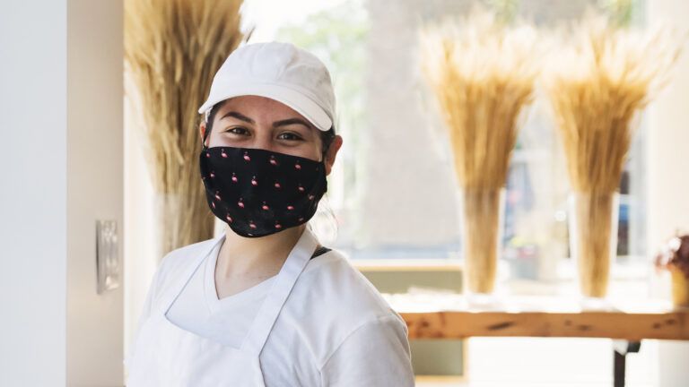 Woman smiling behind mask