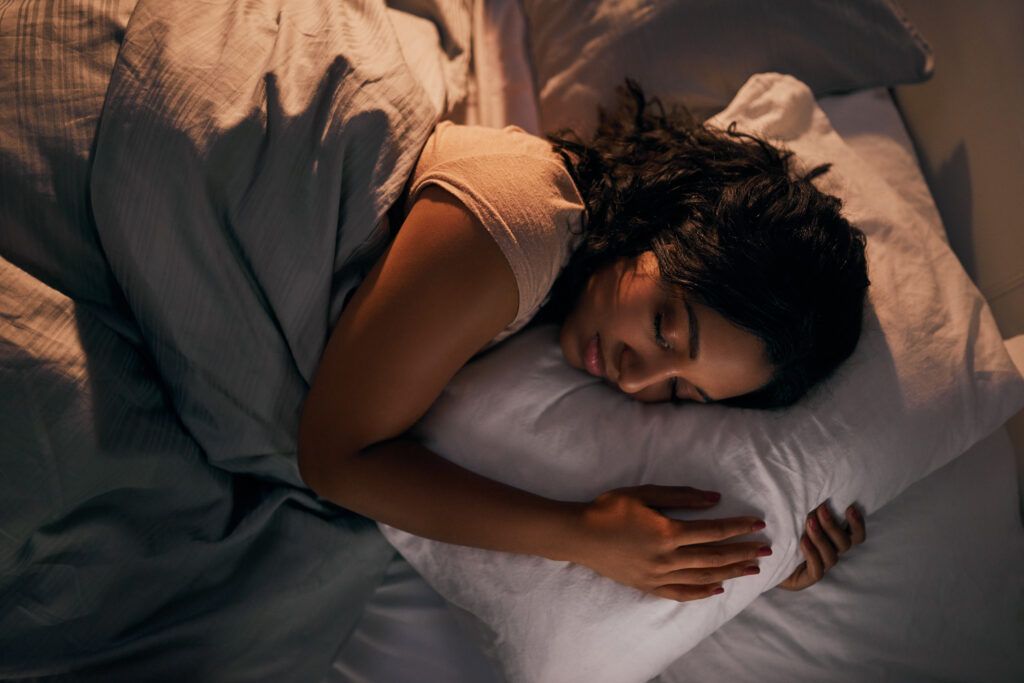 A woman sleeping in bed.