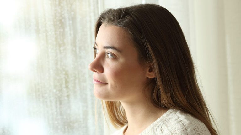 Young woman looking out a window