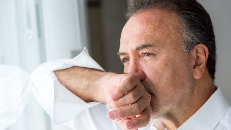 Concerned man looking out a window