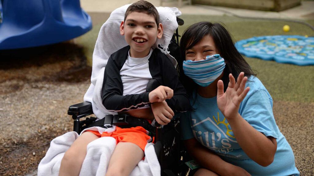 A young boy and a Jills House volunteer