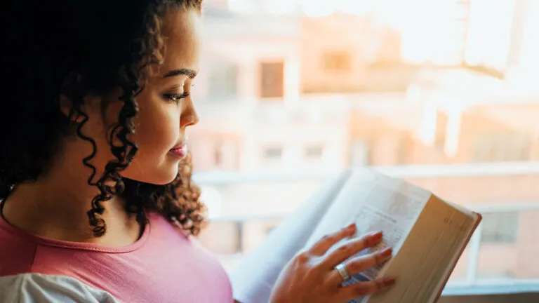 Woman reading the Bible in the morning.