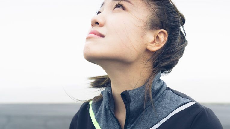 A young woman gazes heavenward in prayer