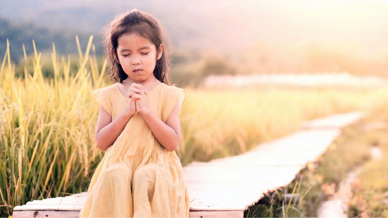 A young girl prays