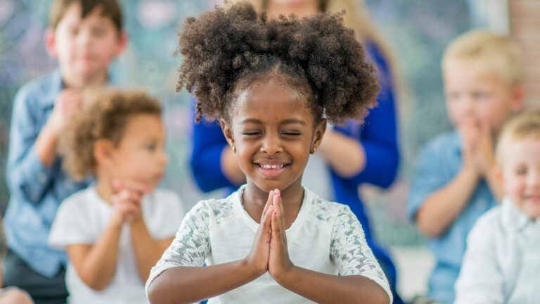 A young girl prays