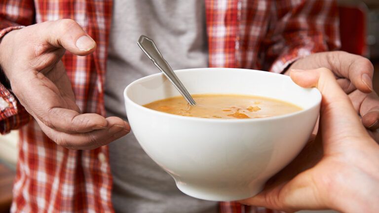 Soup being handed over to someone