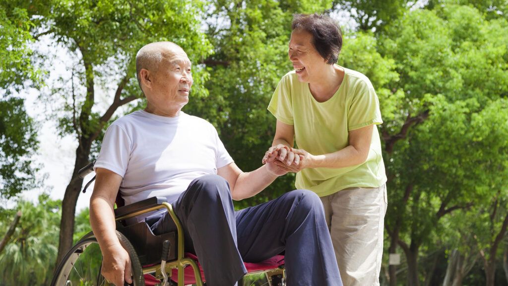 A woman serves as caregiver to her spouse