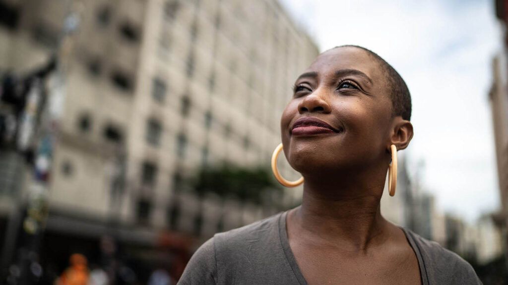 Woman looking up and thinking about books with strong women characters