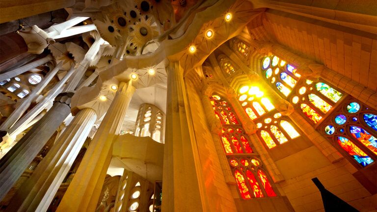 Lights streams through stained glass windows in a church