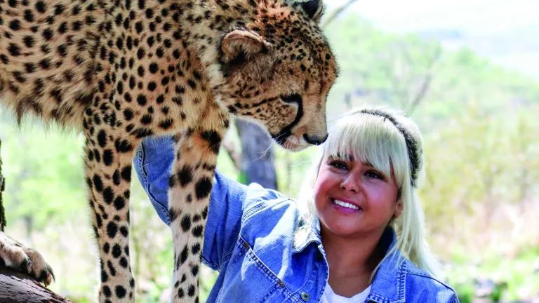 Sonia Perry pets a cheetah