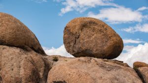 A boulder under a blue sky