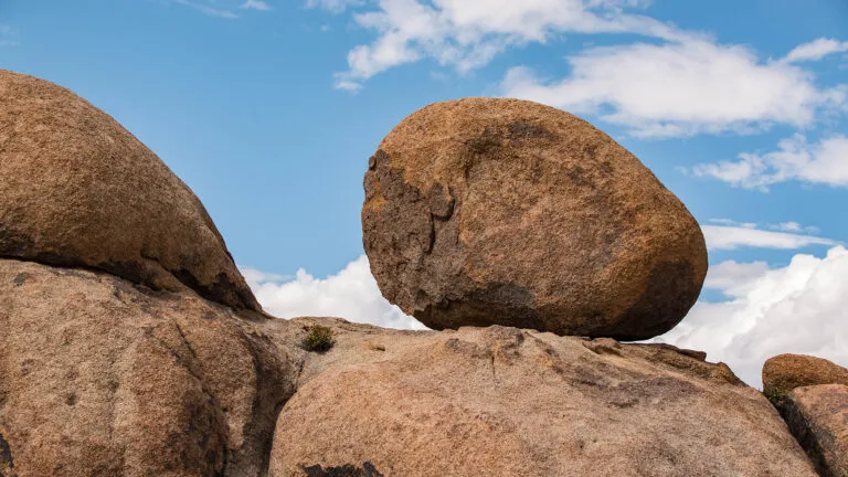 A boulder under a blue sky