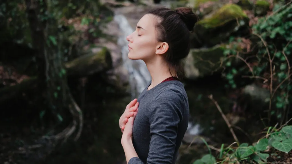 Woman in prayer; Getty Images