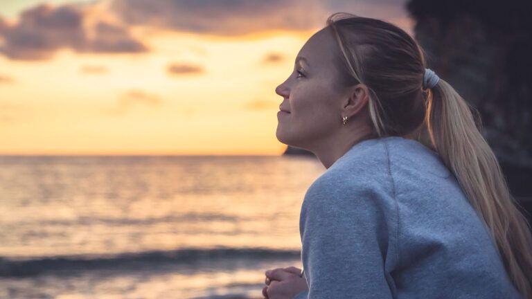 Woman staring out into the water