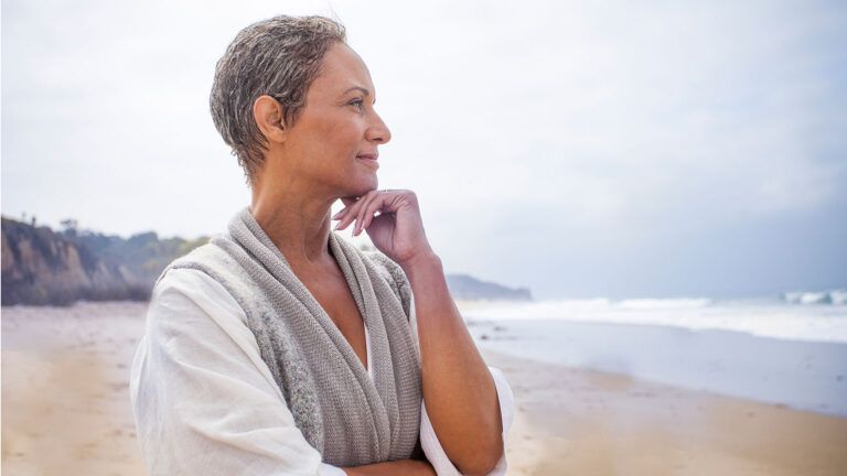 Serene senior woman at the beach