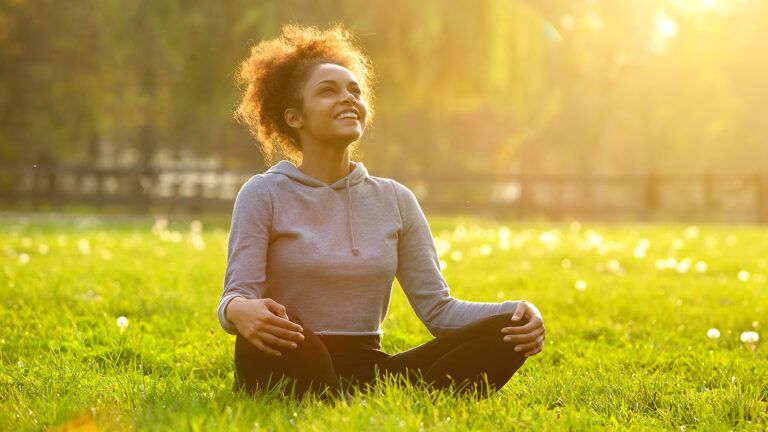 A smiling woman in a sunny field