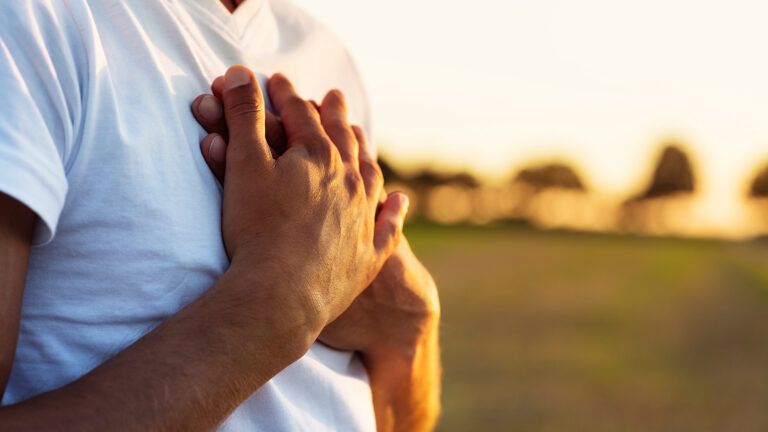 Man holding his hands over his heart