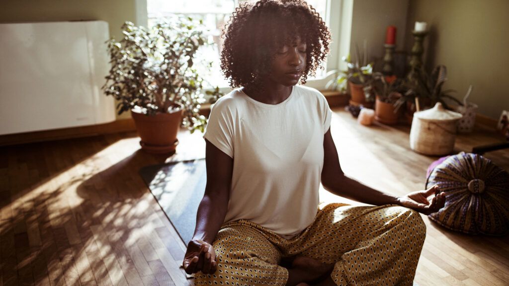 Young man meditating in the morning; Getty Images