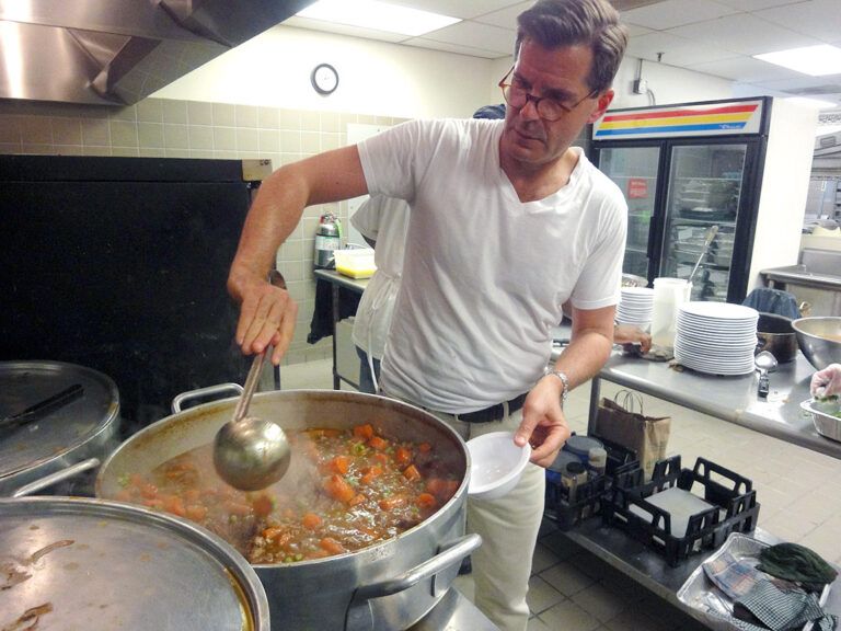 Henderson stirs a pot of beef bourguignonne; photo courtesy Stephen Henderson