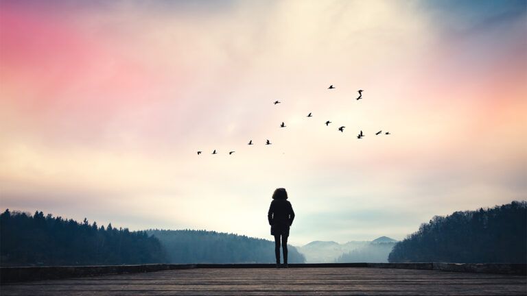 Woman facing a lake