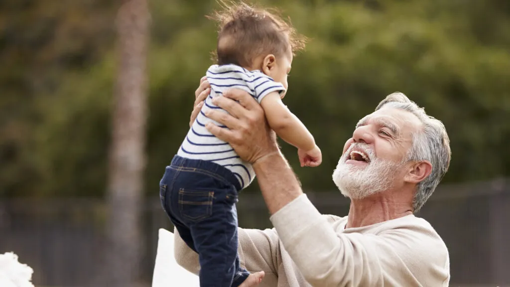 Grandfather holding grandson