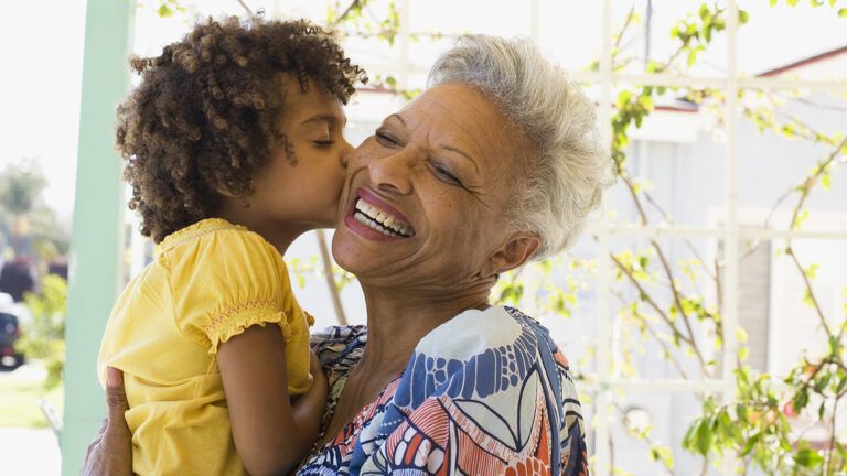 A smiling woman and her grandchild