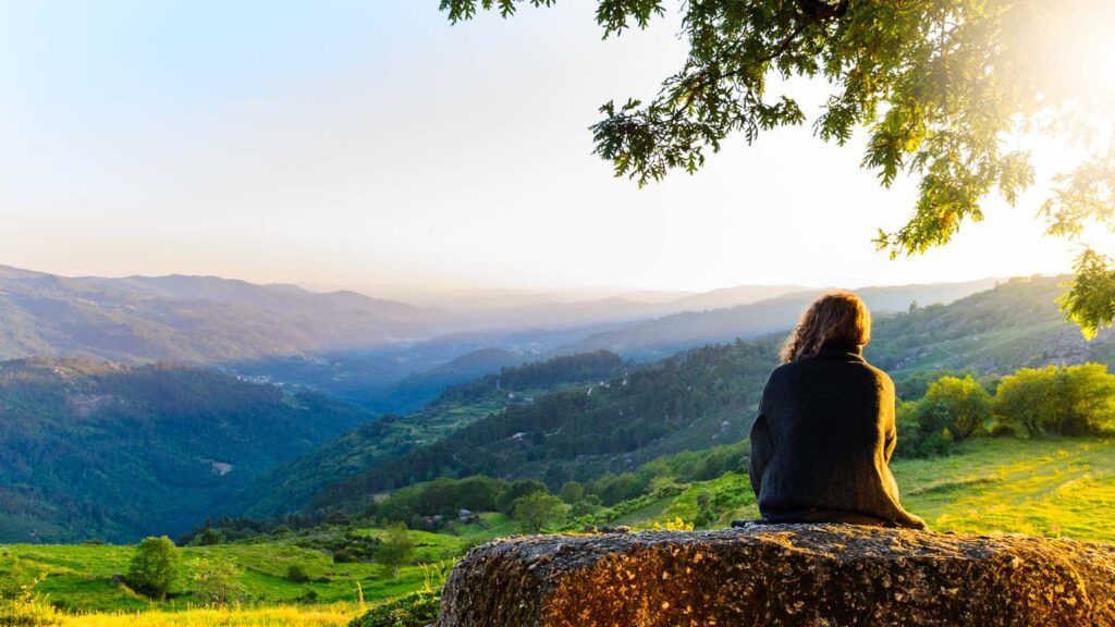 Woman watching sunset in the park; Getty Images