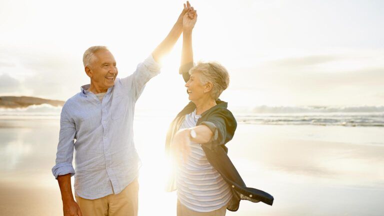 Senior couple dancing on the beach