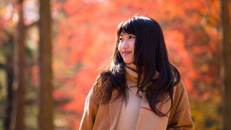 A woman walks in the autumn woods