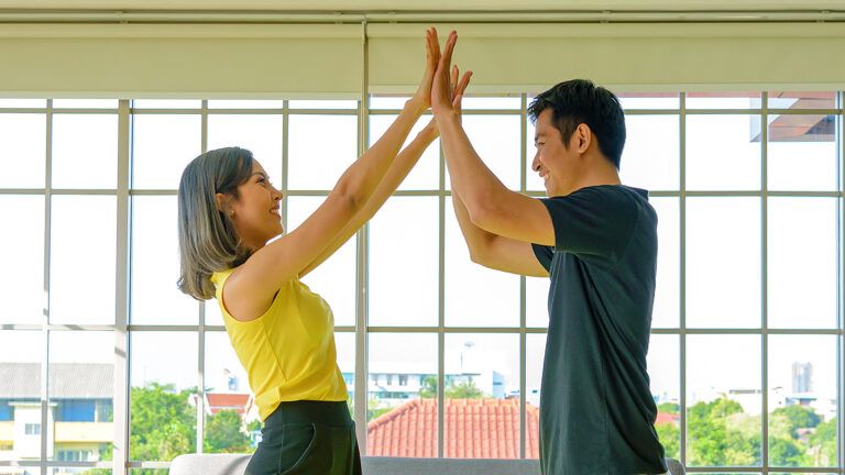 A woman and a man high five