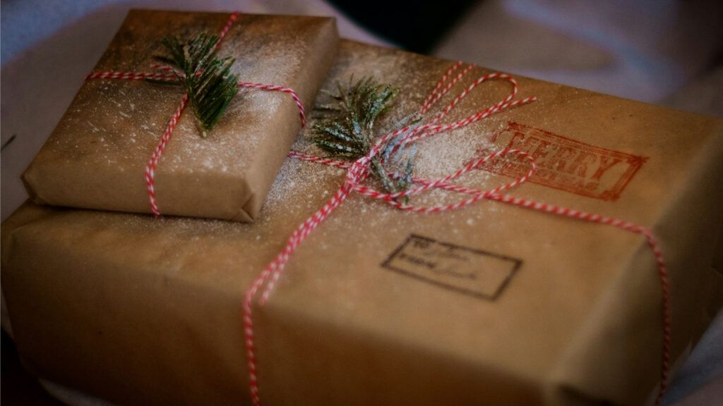 Seasonal gifts wrapped in brown paper and twine.