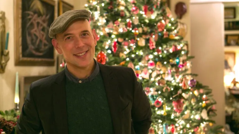 Vintage expert Bob Richter standing in front of a Christmas tree