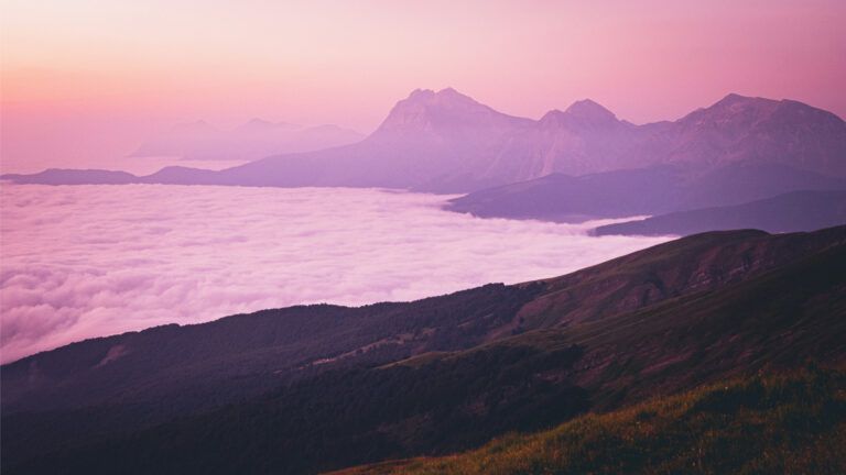 Mountains near a body of water during the day. Credit: Unsplash